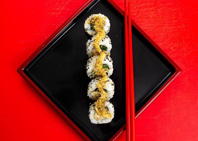 Plate of sushi on red background